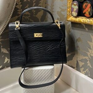 Vintage. Sold as an embossed leather bag. EUC